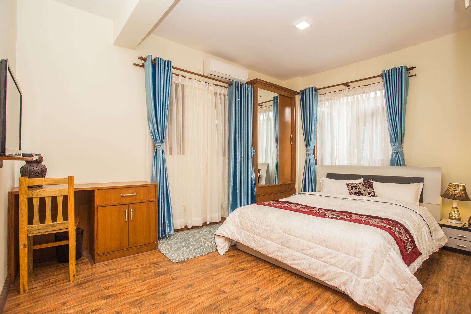 Ama Dablam Suite — the bedroom, bright and air-conditioned