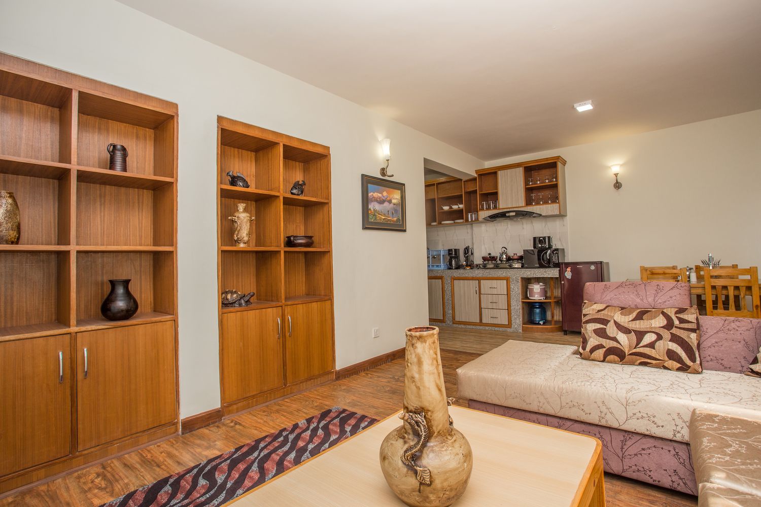 Cho Oyu Suite — living area with display shelves and kitchen beyond