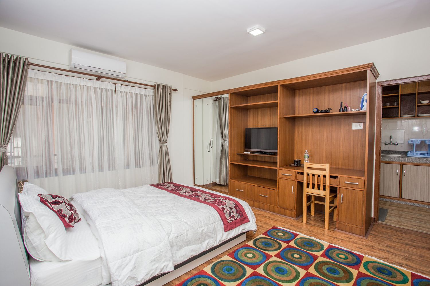 Cho Oyu Suite — bedroom with wardrobe, work desk and tv