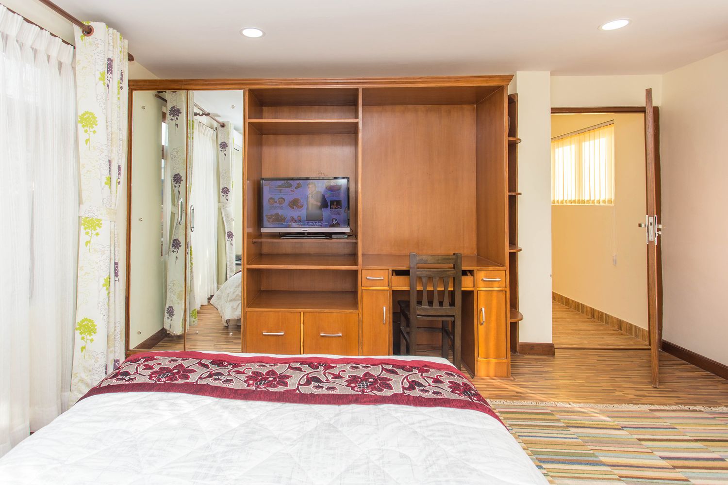 Everest Suite — bedroom with wardrobe, work desk & tv