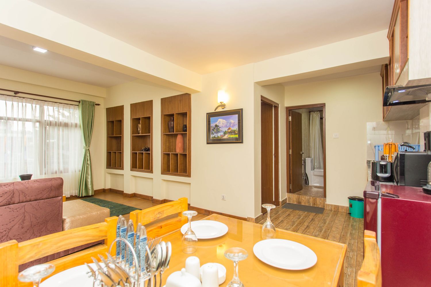Kanchenjunga Suite — dining area, with the kitchen and en-suite beyond