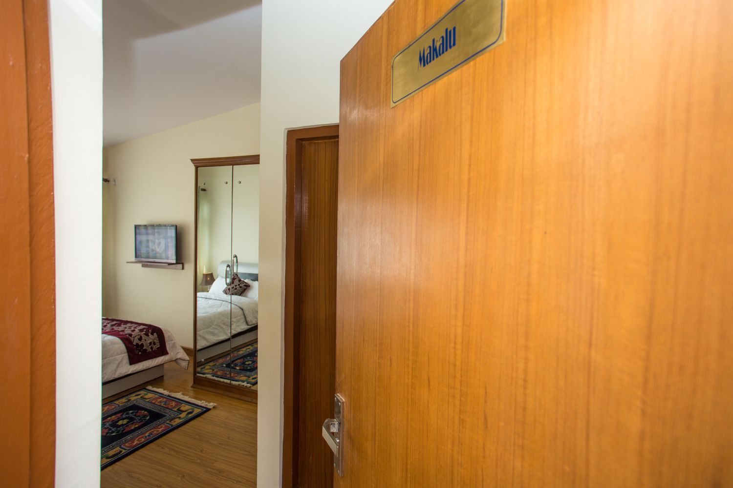 Makalu Plus — bedroom with wall-mounted tv and wardrobe