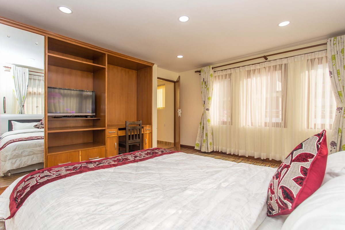 Everest Suite bedroom with writing desk and smart TV