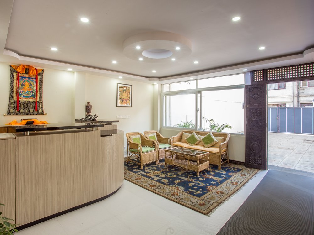 Karma Tara reception lounge with thangka art and carved Newari doors