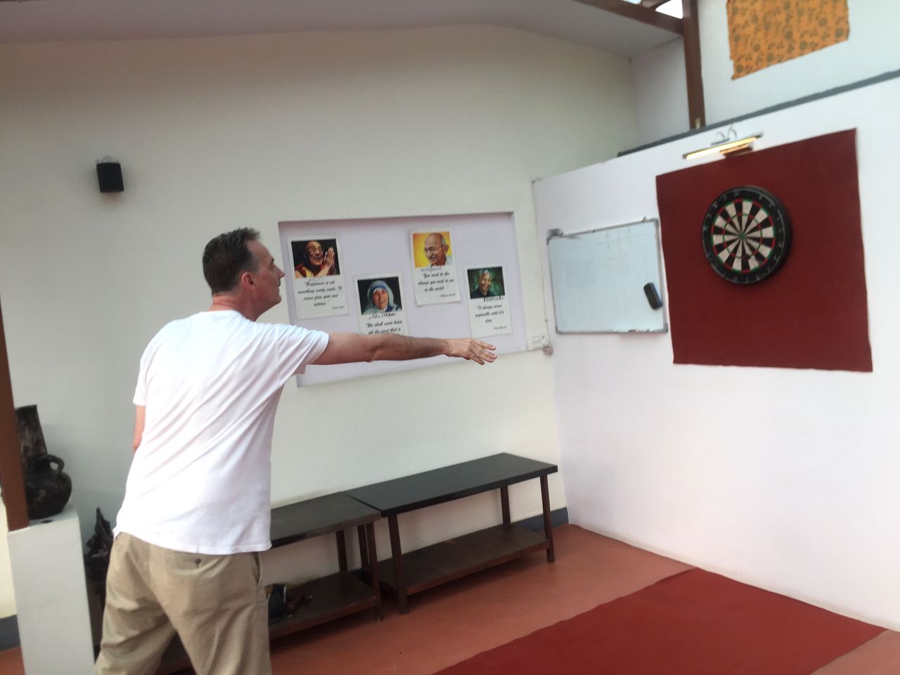A guest throwing a dart at a dartboard in the terrace games area